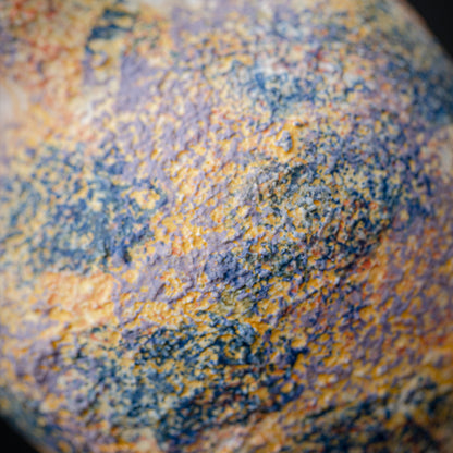 Close-up of a textured surface with orange and blue colors