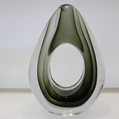 Modern glass vase with a teardrop shape on a white background