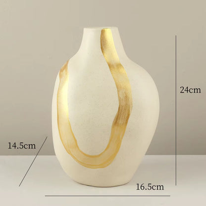 White vase with gold accents on a neutral background, showing measurements.