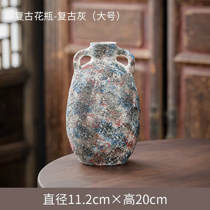 Decorative vase with multicolored speckles on a wooden surface with a blurred background