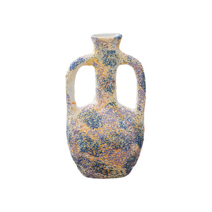 Decorative vase with a speckled pattern on a white background