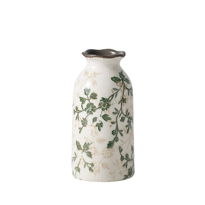 Decorative vase with green leaf patterns on a white background
