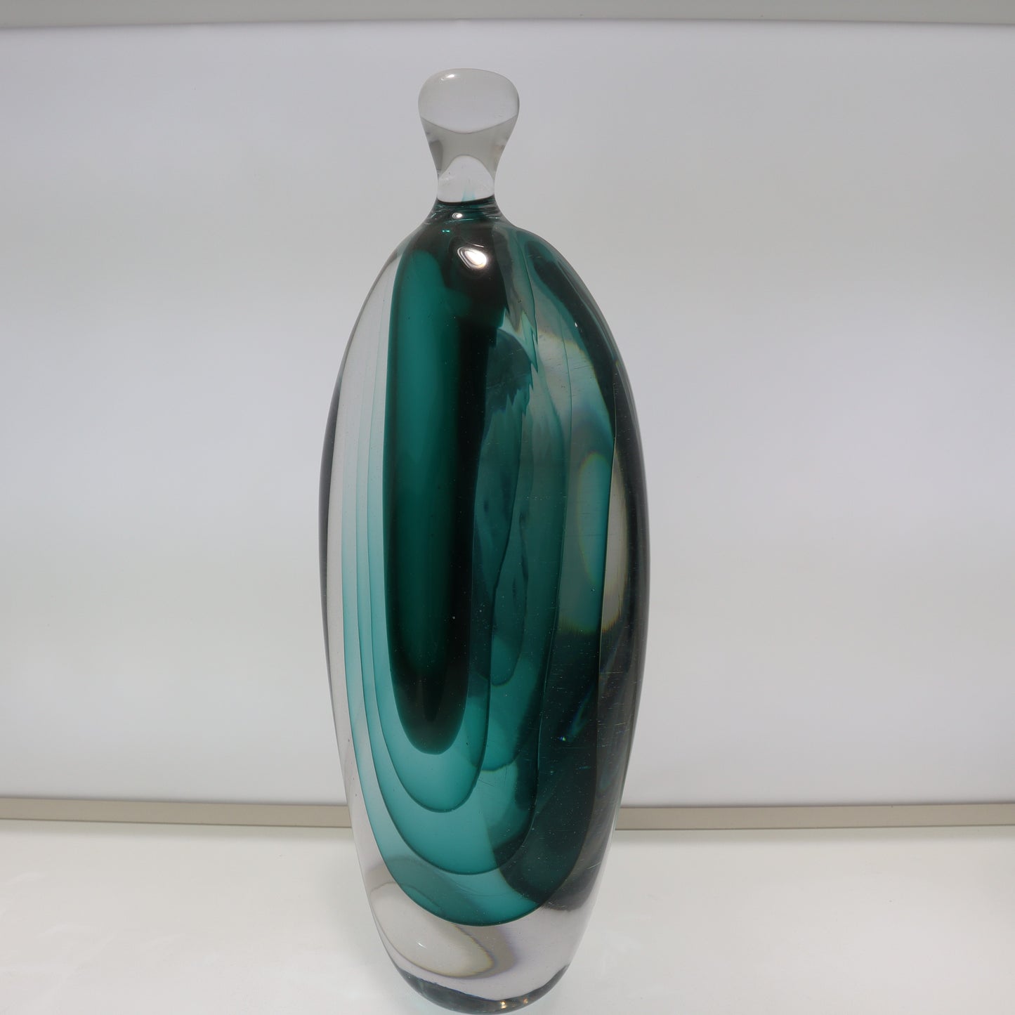 Green glass vase on a white background
