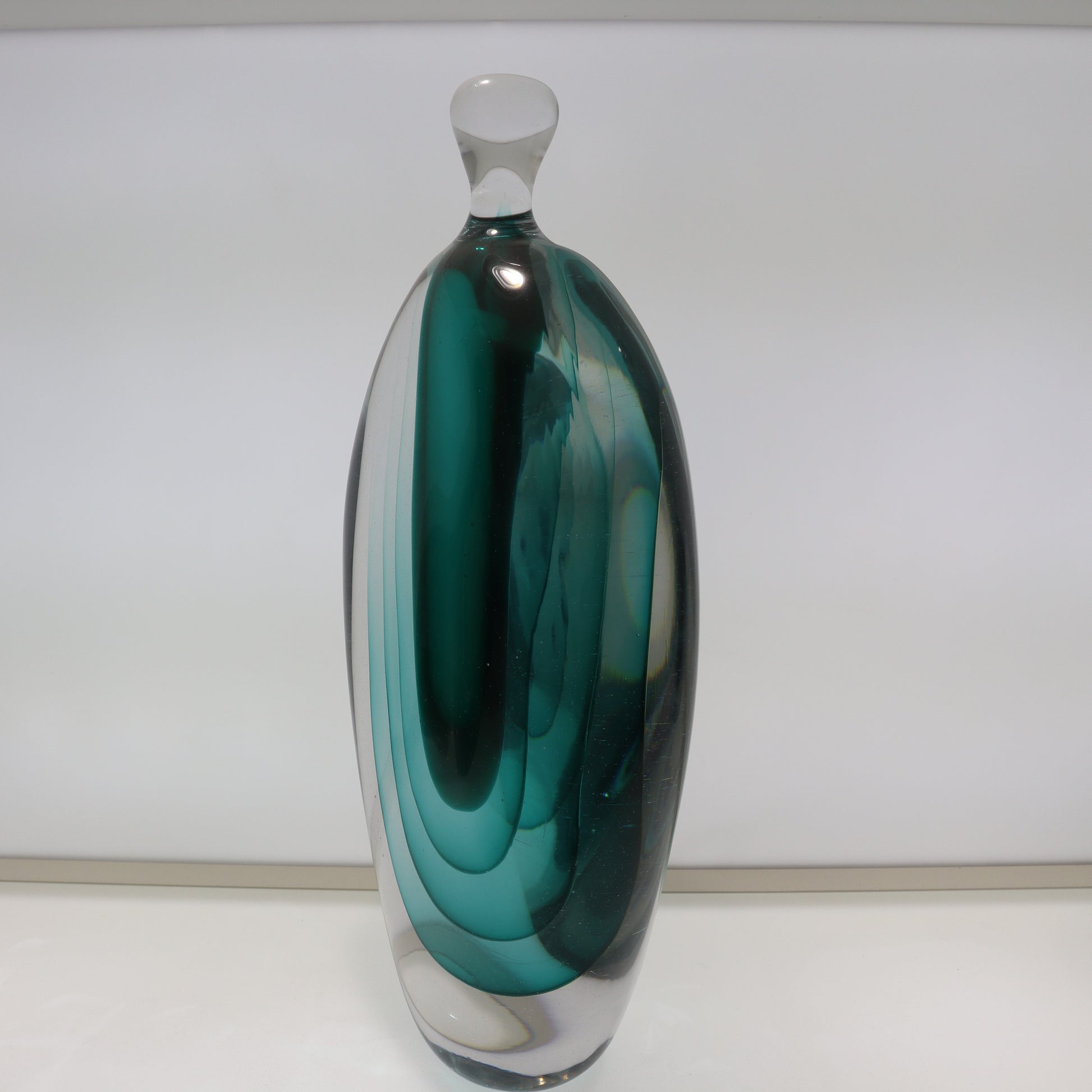 Green glass vase on a white background