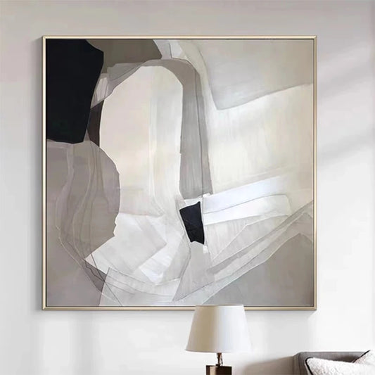 Abstract art piece in a gold frame on a wall