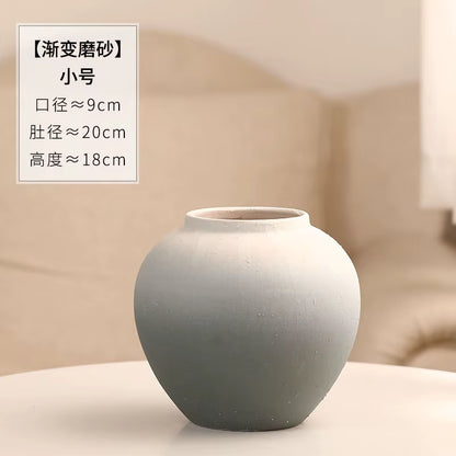 Gray ceramic vase on a beige background with text overlay