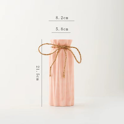 Pink bottle with twine measurement details on a white background