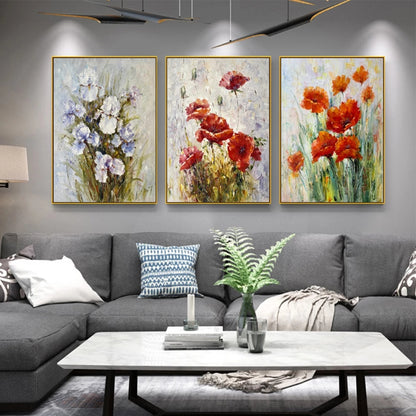 Living room with gray sectional sofa and three floral paintings on the wall.