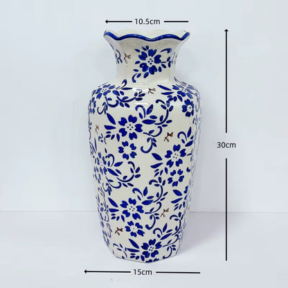 Ceramic vase with blue floral patterns and measurements on a white background