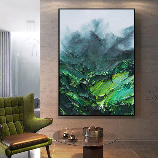 Abstract painting in a modern living room with a green chair and glass table.