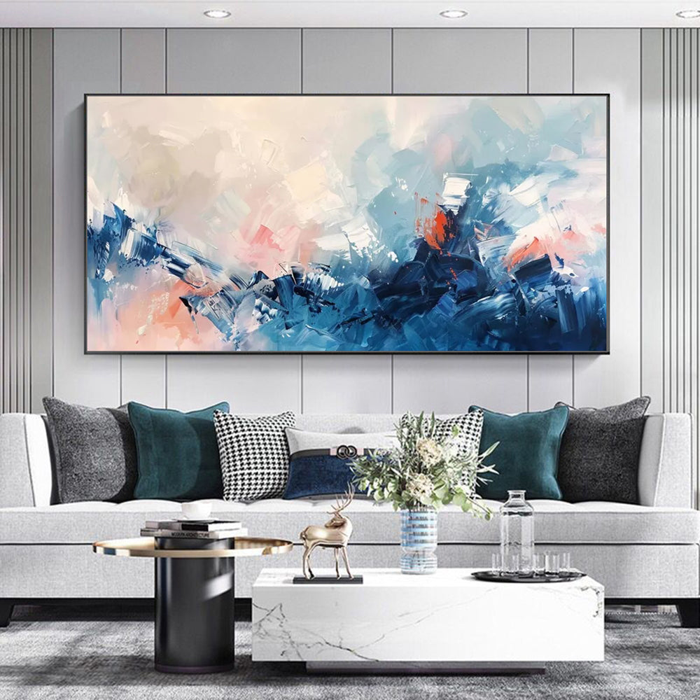 Modern living room with a gray sofa, abstract painting, and decorative items.