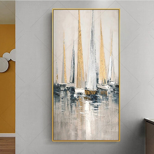Abstract painting of sailboats with a gold frame on a gray wall.