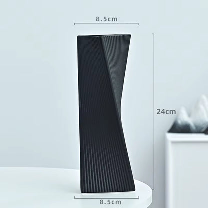 Black textured vase with dimensions on a light gray background