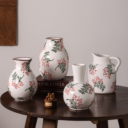 Set of ceramic vases with floral patterns on a wooden table