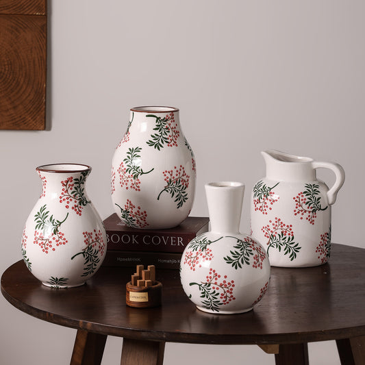 Set of ceramic vases with floral patterns on a wooden table