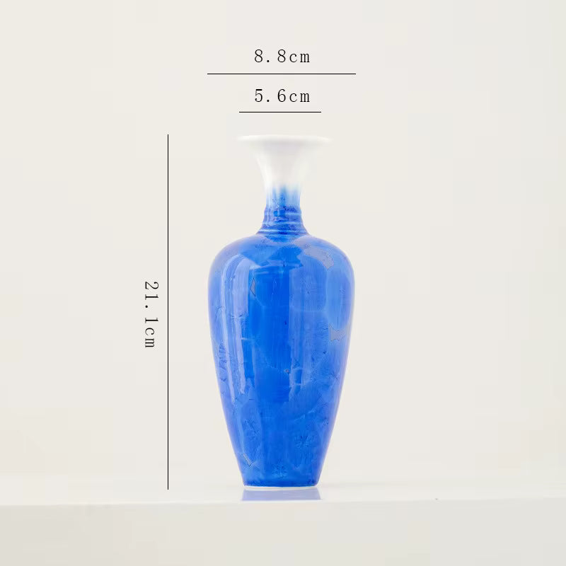 Blue ceramic vase with dimensions on a white background
