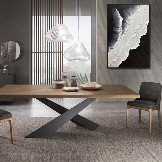 Modern dining room with a wooden table and gray chairs, featuring abstract art on the wall.