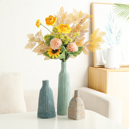 Decorative vases with a bouquet of flowers on a white surface.