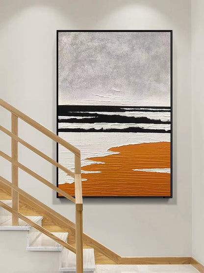 Abstract art piece with black, white, and orange on a wall above a staircase.
