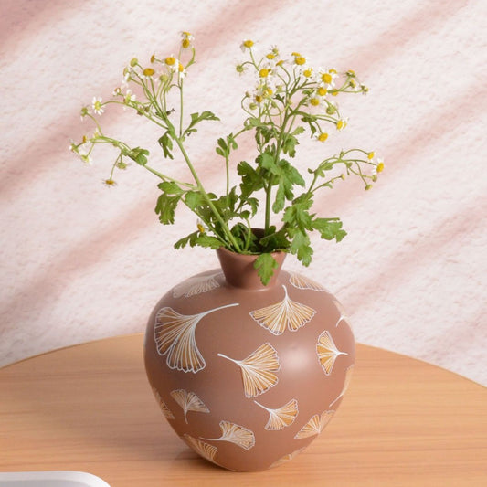 Decorative vase with floral design on a wooden surface