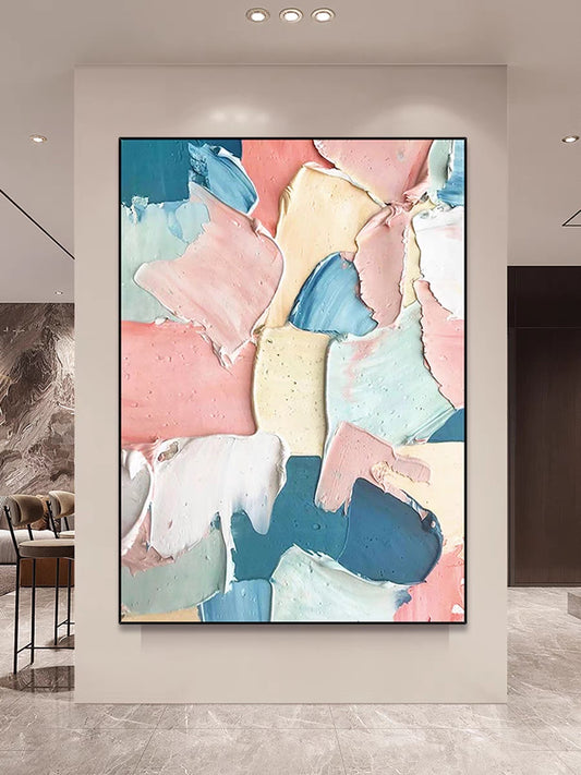 Abstract art piece with pastel colors on a wall in a modern interior setting.