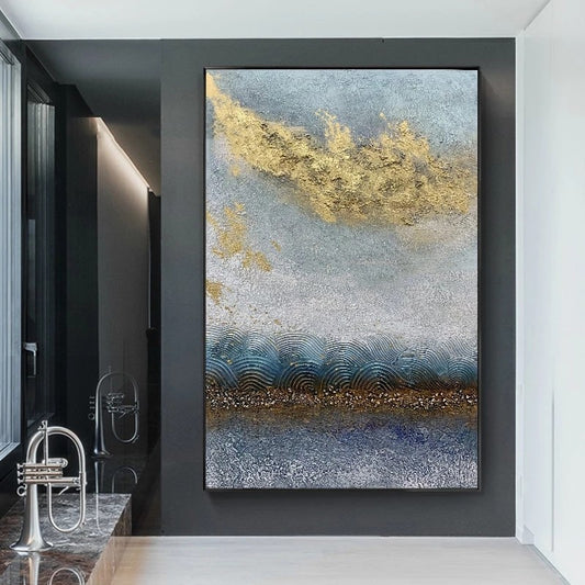 Abstract art piece with gold and blue tones on a dark wall