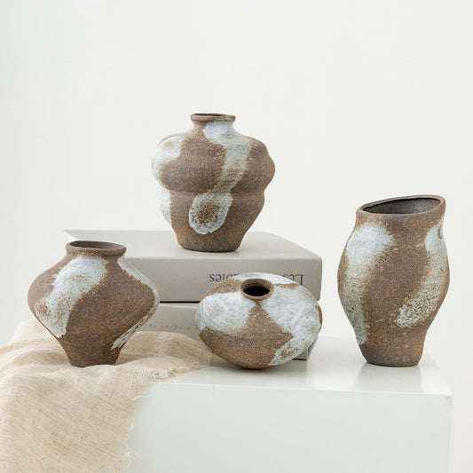 Set of ceramic vases with brown and white patterns on a light background