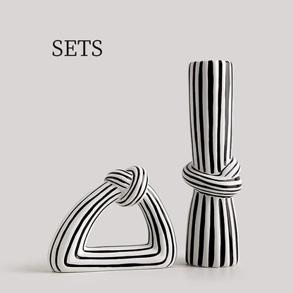 Two black and white striped ceramic vases on a light gray background with 'SETS' text.