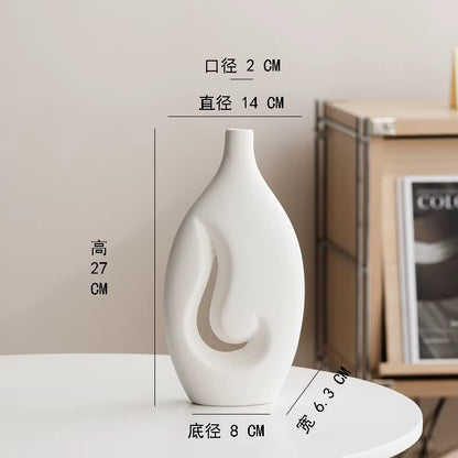 White decorative vase with measurements on a white surface