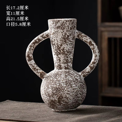 Decorative ceramic vase with handles on a dark surface