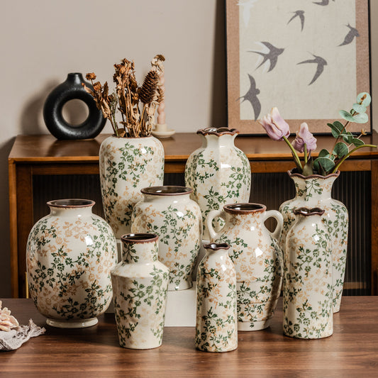 Collection of decorative vases with floral patterns on a wooden surface.
