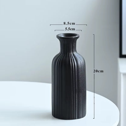 Black textured vase on a white surface with dimensions indicated