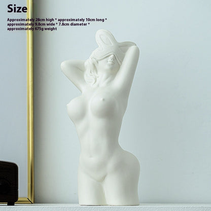 White abstract sculpture of a nude figure on a light gray background