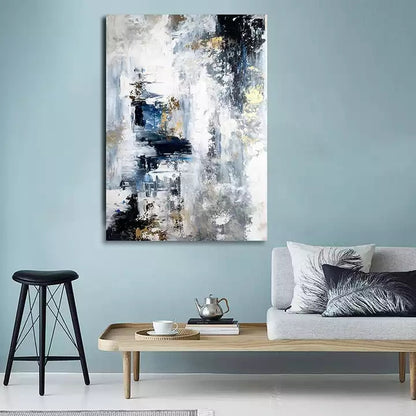 Abstract painting on a wall above a sofa and coffee table in a living room.