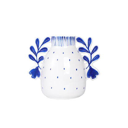 White mug with blue floral designs on a white background