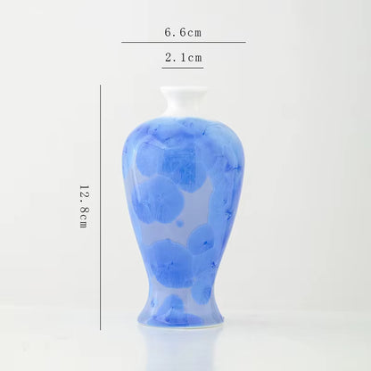 Blue ceramic vase with measurements on a white background