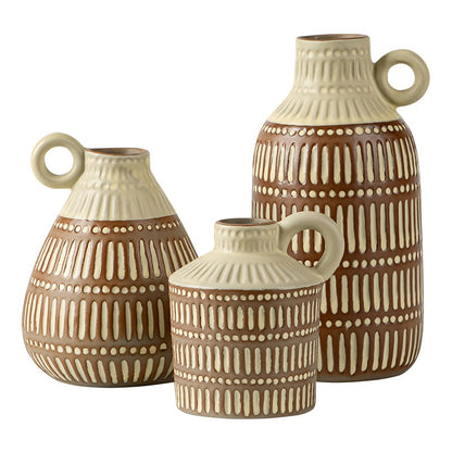 Three ceramic vases with brown and beige patterns on a white background