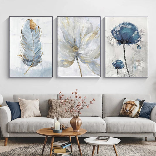 Three abstract floral artworks above a gray sofa in a living room.