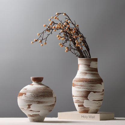 Two ceramic vases with textured design on a gray background