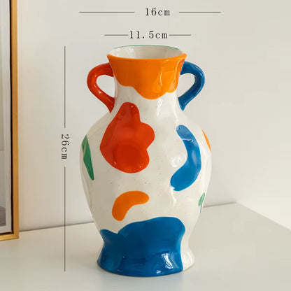 Colorful ceramic vase with abstract patterns and measurements on a white background