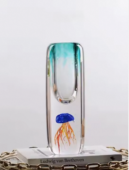 Glass vase with a jellyfish design on a white surface