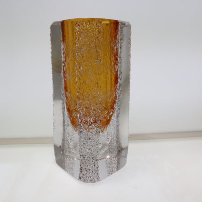 Glass vase with amber top and clear base on a white background