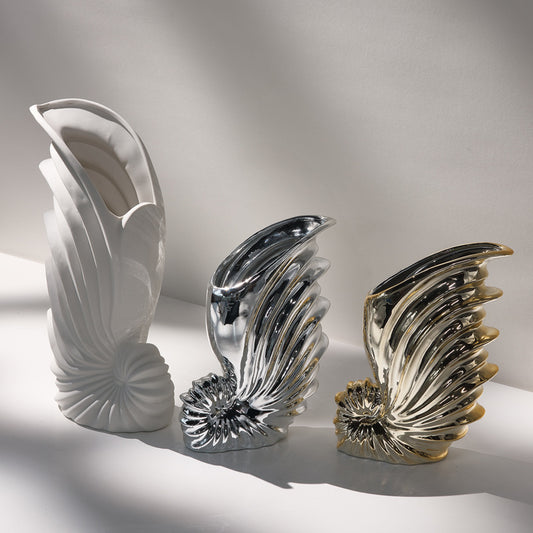 Three decorative vases with unique designs on a light background