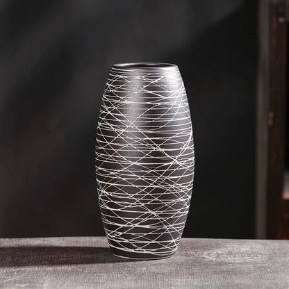 Decorative vase with black and white pattern on a dark background