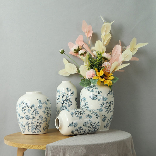 Set of floral-patterned vases with a bouquet on a gray background