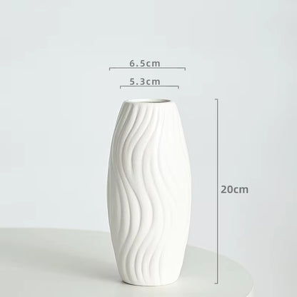 White ceramic vase with measurements on a light gray background