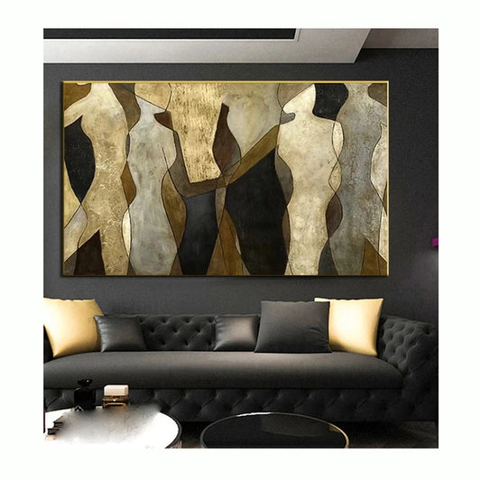 Abstract art piece on a wall above a black sofa with decorative pillows.