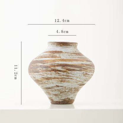 Ceramic vase with measurement markings on a white background