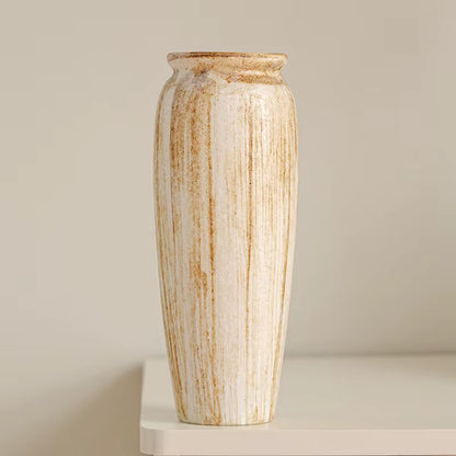 Tall ceramic vase with striped pattern on a neutral background