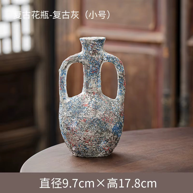Decorative vase with multicolored speckled pattern on a wooden surface